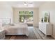 Bright bedroom featuring a ceiling fan, sliding glass doors, and a stylish dresser with a mirror at 220 Wimbledon Cir, Lake Mary, FL 32746