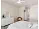 Light-filled bedroom showcasing a wicker chair, modern dresser, and neutral decor at 220 Wimbledon Cir, Lake Mary, FL 32746