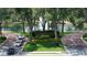 Community entrance with water fountain, trees, manicured landscaping, and clear signage at 220 Wimbledon Cir, Lake Mary, FL 32746