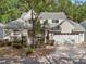 Charming two-story home featuring stone accents, a well-manicured lawn, and a two-car garage at 220 Wimbledon Cir, Lake Mary, FL 32746