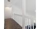 Hallway with railing overlooking the living area, lots of light and hardwood flooring at 220 Wimbledon Cir, Lake Mary, FL 32746
