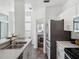 Well-lit kitchen featuring stainless steel appliances, sleek white cabinets, and wood-look flooring at 220 Wimbledon Cir, Lake Mary, FL 32746