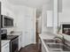 Bright kitchen showcasing white cabinets, stainless steel appliances, and modern fixtures at 220 Wimbledon Cir, Lake Mary, FL 32746