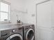 A convenient laundry room with modern washer and dryer units at 220 Wimbledon Cir, Lake Mary, FL 32746
