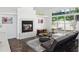 Inviting living room features a fireplace, large windows, and comfortable seating at 220 Wimbledon Cir, Lake Mary, FL 32746
