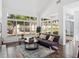 Spacious living room with vaulted ceilings and large windows overlooking the backyard at 220 Wimbledon Cir, Lake Mary, FL 32746