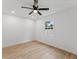 Bedroom with a ceiling fan, one window, and light wood-look flooring at 2205 Pine Island Dr, New Smyrna Beach, FL 32168