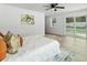 Cozy bedroom with a ceiling fan, artwork, and access to the pool area at 2205 Pine Island Dr, New Smyrna Beach, FL 32168