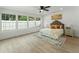 Bright bedroom with large windows, a ceiling fan, and neutral decor at 2205 Pine Island Dr, New Smyrna Beach, FL 32168