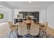 Open-concept dining room adjacent to a modern kitchen with gray cabinets and a large island at 2205 Pine Island Dr, New Smyrna Beach, FL 32168