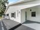 Close up front view of home showing grey painted deck and turquoise door at 2205 Pine Island Dr, New Smyrna Beach, FL 32168