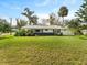 Picture of the home's front exterior showing a luscious green lawn at 2205 Pine Island Dr, New Smyrna Beach, FL 32168