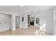 Open-concept interior with light wood-look floors and white walls at 2205 Pine Island Dr, New Smyrna Beach, FL 32168
