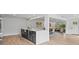 Open kitchen with a large island, stainless steel sink, and view to the dining and living areas at 2205 Pine Island Dr, New Smyrna Beach, FL 32168