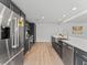 Updated kitchen with stainless steel appliances, large island, and sleek gray cabinetry at 2205 Pine Island Dr, New Smyrna Beach, FL 32168
