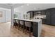 A modern kitchen featuring a large island with seating, gray cabinets, and stainless steel appliances at 2205 Pine Island Dr, New Smyrna Beach, FL 32168