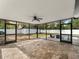 Screened-in patio featuring brick flooring, a ceiling fan, and a pool view at 2205 Pine Island Dr, New Smyrna Beach, FL 32168