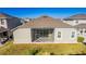 Aerial view of backyard, featuring screened lanai, grassy area, and well-maintained landscaping at 2417 Annacella Ave, Kissimmee, FL 34741