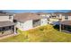 Aerial view of backyard showing screened lanai, lush grass and close proximity to neighbors at 2417 Annacella Ave, Kissimmee, FL 34741