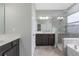 This bathroom features double sinks, a walk-in shower, and a bathtub at 2417 Annacella Ave, Kissimmee, FL 34741