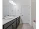 Bathroom featuring double vanity, quartz counters, and updated fixtures at 2417 Annacella Ave, Kissimmee, FL 34741