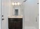 Bathroom featuring a glass shower, quartz counters, and updated sink at 2417 Annacella Ave, Kissimmee, FL 34741