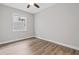 Bright bedroom features modern ceiling fan, hardwood floors and a window at 2417 Annacella Ave, Kissimmee, FL 34741