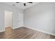 Bedroom with an open closet door, ceiling fan, and light hardwood floors at 2417 Annacella Ave, Kissimmee, FL 34741