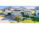 Inviting single-Gathering home featuring a brick driveway, well-manicured lawn, and an attached three-car garage at 2417 Annacella Ave, Kissimmee, FL 34741
