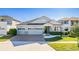 Beautiful single-Gathering home featuring a well-kept lawn, brick driveway, and attached three-car garage at 2417 Annacella Ave, Kissimmee, FL 34741