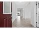 Bright foyer with tile floors, leading to open living spaces filled with natural light and neutral color palette at 2417 Annacella Ave, Kissimmee, FL 34741