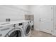 Bright laundry room with modern appliances, sink, wire rack and tile flooring at 2417 Annacella Ave, Kissimmee, FL 34741