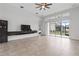 The bright living area boasts large windows, sliding glass doors and tiled floor at 2417 Annacella Ave, Kissimmee, FL 34741