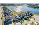 Aerial view of a neighborhood featuring lake, fountain, sidewalks, and meticulously maintained homes at 2417 Annacella Ave, Kissimmee, FL 34741