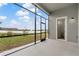 Relaxing screened-in lanai with stunning lake views and a convenient outdoor entry to bathroom at 2417 Annacella Ave, Kissimmee, FL 34741