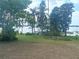 Spacious backyard featuring mature landscaping and waterfront views at 2603 E Lake Hartridge Dr, Winter Haven, FL 33881
