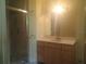 Bathroom featuring a shower with glass door, vanity with cabinets and a large mirror at 2603 E Lake Hartridge Dr, Winter Haven, FL 33881