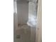 Small vintage bathroom with pedestal sink, tiled shower and floor, and classic fixtures at 2603 E Lake Hartridge Dr, Winter Haven, FL 33881
