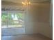Dining room with chandelier and door leading to a deck with lake view at 2603 E Lake Hartridge Dr, Winter Haven, FL 33881