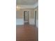 Dining room featuring hardwood floors, decorative wallpaper, and classic chandelier at 2603 E Lake Hartridge Dr, Winter Haven, FL 33881