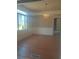 Traditional dining room with hardwood floors, decorative chandelier, and ample natural light at 2603 E Lake Hartridge Dr, Winter Haven, FL 33881