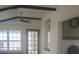 Inviting living space showcasing beamed ceilings, multiple windows, and adjacent fireplace at 2603 E Lake Hartridge Dr, Winter Haven, FL 33881