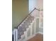 Elegant staircase with wooden banister and paneled walls, offering a classic touch at 2603 E Lake Hartridge Dr, Winter Haven, FL 33881