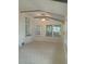 Bright sunroom with tile floors, large windows, and a ceiling fan for added comfort at 2603 E Lake Hartridge Dr, Winter Haven, FL 33881