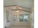 Bright sun room with large windows and neutral tones and ceiling fan at 2603 E Lake Hartridge Dr, Winter Haven, FL 33881