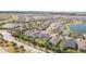 Community aerial view showcasing multiple homes, ponds, and a well-maintained roadway at 2604 Meadowedge Loop, St Cloud, FL 34772