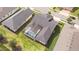 Aerial view featuring a screened pool, with backyard, lush lawn, and manicured landscaping at 2604 Meadowedge Loop, St Cloud, FL 34772