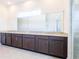 Bathroom vanity with dual sinks, granite countertop and dark cabinets at 2604 Meadowedge Loop, St Cloud, FL 34772