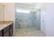 Modern bathroom featuring a spacious shower with glass enclosure and granite countertops at 2604 Meadowedge Loop, St Cloud, FL 34772