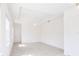Bright bedroom featuring a tray ceiling with fan and neutral tile flooring at 2604 Meadowedge Loop, St Cloud, FL 34772